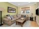 Spacious living room with a large sectional sofa and hardwood floors at 1205 Gulf Way, St Pete Beach, FL 33706
