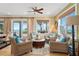 Relaxing living room boasts stunning ocean views and comfortable wicker furniture at 1205 Gulf Way, St Pete Beach, FL 33706