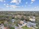 Overhead shot of a residential area with mature trees, pools, and well-maintained lawns at 12840 Sophia Cir, Largo, FL 33774