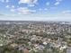 Expansive aerial view of a residential neighborhood with lush trees and distant ocean view at 12840 Sophia Cir, Largo, FL 33774