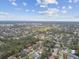 Expansive aerial view of a residential community with tree-lined streets, nearby golf course, and cityscape in distance at 12840 Sophia Cir, Largo, FL 33774