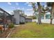 Large backyard with a screened-in pool and mature trees, offering privacy and space for outdoor activities at 12840 Sophia Cir, Largo, FL 33774