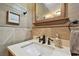 Charming bathroom vanity featuring an elegant faucet, neutral tones, and rustic decorative elements at 12840 Sophia Cir, Largo, FL 33774