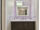Modern bathroom with lighted mirror, stylish vanity, and elegant tile accents at 12840 Sophia Cir, Largo, FL 33774