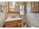 Cozy bathroom vanity featuring bronze fixtures, decorative tile and plenty of storage underneath at 12840 Sophia Cir, Largo, FL 33774