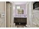 Bathroom features a backlit mirror over the dark wood vanity, with marble-look tiled walls and flooring at 12840 Sophia Cir, Largo, FL 33774
