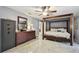 Stylish bedroom with dark wood furniture, gray walls, tile flooring, and a large window at 12840 Sophia Cir, Largo, FL 33774
