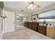 Spacious bedroom with a wall of mirrored closet doors, neutral walls, carpet flooring, and warm decor at 12840 Sophia Cir, Largo, FL 33774