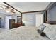 Bedroom features tile flooring, dark wood four-poster bed, dark dresser, and stylish decor at 12840 Sophia Cir, Largo, FL 33774