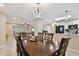 The dining area features a wooden table, connecting the game room and kitchen in an open floor plan under modern lighting at 12840 Sophia Cir, Largo, FL 33774