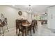 The dining area offers an ornate table, view of the game room and connects to the kitchen, all under a stylish light fixture at 12840 Sophia Cir, Largo, FL 33774