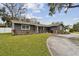 Lovely home with a spacious front yard, stone accents, and a welcoming entrance with a circular driveway at 12840 Sophia Cir, Largo, FL 33774