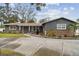 Charming single-story home with stone accents, landscaped yard, and a circular driveway leading to the entrance at 12840 Sophia Cir, Largo, FL 33774