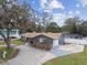Charming home with lush green lawn, mature trees, and beautiful landscaping at 12840 Sophia Cir, Largo, FL 33774