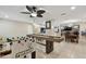 The game room features a shuffleboard and foosball table and connects to the kitchen, dining and living areas at 12840 Sophia Cir, Largo, FL 33774