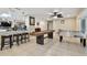 The open game room features a shuffleboard table and foosball, connecting seamlessly to other living spaces in the home at 12840 Sophia Cir, Largo, FL 33774