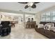 Open-concept living room featuring tile flooring, a unique ceiling fan, dining area, and an eat-in kitchen at 12840 Sophia Cir, Largo, FL 33774