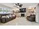 Bright living room boasts a stone fireplace, floating shelves, tile flooring, and comfortable seating at 12840 Sophia Cir, Largo, FL 33774