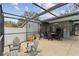 Spacious screened-in patio featuring dining and lounging areas for relaxing or entertaining at 12840 Sophia Cir, Largo, FL 33774