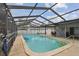 Clean screened-in pool featuring ladder access, and ample space for recreation at 12840 Sophia Cir, Largo, FL 33774