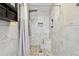 Elegant bathroom showcasing a tiled shower with a built-in seat and decorative stone pebble floor design at 12840 Sophia Cir, Largo, FL 33774