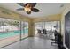 Bright sunroom with tile floor, ceiling fan and a clear view of the pool and patio areas at 12840 Sophia Cir, Largo, FL 33774