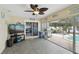 Bright sunroom with tile floor, ceiling fan and views of the pool and backyard at 12840 Sophia Cir, Largo, FL 33774