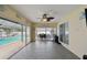 Bright sunroom with tile floor, ceiling fan and clear access to the patio and backyard at 12840 Sophia Cir, Largo, FL 33774
