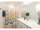 Bathroom with a tub shower, white vanity, and fish-themed shower curtain at 12902 Brookside Moss Dr, Riverview, FL 33579