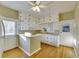 White kitchen cabinets, wood floors, and a breakfast bar at 1304 E 32Nd Ave, Tampa, FL 33603