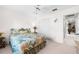 Comfortable bedroom with a floral bedspread and ceiling fan at 1375 Carlisle Ct, Dunedin, FL 34698