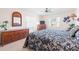 Spacious bedroom with king-size bed, dresser, and ceiling fan at 1375 Carlisle Ct, Dunedin, FL 34698