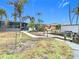 Backyard features a walkway to the canal and a screened patio at 141 Singapore Rd, Punta Gorda, FL 33950