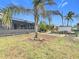 Spacious backyard with canal access and tropical landscaping at 141 Singapore Rd, Punta Gorda, FL 33950