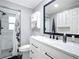 Modern bathroom with a walk-in shower and white cabinets at 141 Singapore Rd, Punta Gorda, FL 33950