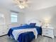 Well-lit bedroom, featuring a queen bed and white dresser at 141 Singapore Rd, Punta Gorda, FL 33950