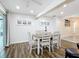 Bright dining area with table and chairs, hardwood floors, and access to kitchen at 141 Singapore Rd, Punta Gorda, FL 33950
