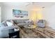 Bright and airy living room featuring comfy seating and a large TV at 141 Singapore Rd, Punta Gorda, FL 33950
