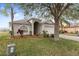 House with a well-maintained lawn and landscaping at 18452 Merseyside Loop, Land O Lakes, FL 34638