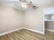 Bright bedroom with wood-look floors and access to a loft area at 18817 Chaville Rd, Lutz, FL 33558