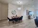 Elegant dining room with a wooden table, blue chairs, and modern chandelier at 2026 20Th Avenue Pkwy, Indian Rocks Beach, FL 33785