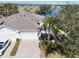 Attractive villa with a two-car garage and lush landscaping near a lake at 2071 Sifield Greens Way # 103, Sun City Center, FL 33573