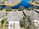 Property features a two car garage and a view of the lake at 2071 Sifield Greens Way # 103, Sun City Center, FL 33573