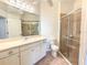 Bathroom featuring a walk-in shower and toilet at 2071 Sifield Greens Way # 103, Sun City Center, FL 33573