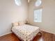 Bedroom with wood floors and unique round windows at 2071 Sifield Greens Way # 103, Sun City Center, FL 33573