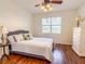 Bedroom with a view, wood floors, and white dresser at 2071 Sifield Greens Way # 103, Sun City Center, FL 33573