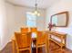 Bright dining room featuring a wood table and chairs, and a decorative mirror at 2071 Sifield Greens Way # 103, Sun City Center, FL 33573