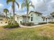 Single-story house, two-car garage, palm trees at 2071 Sifield Greens Way # 103, Sun City Center, FL 33573