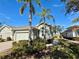 Well-maintained villa with a two-car garage and neatly landscaped grounds at 2071 Sifield Greens Way # 103, Sun City Center, FL 33573