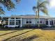 Back of house, sunroom addition, grassy yard at 2071 Sifield Greens Way # 103, Sun City Center, FL 33573